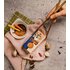 Asian BBQ spice pack next to a bowl with marinade, ginger, garlic and chopsticks on a light Asian-decorated background.